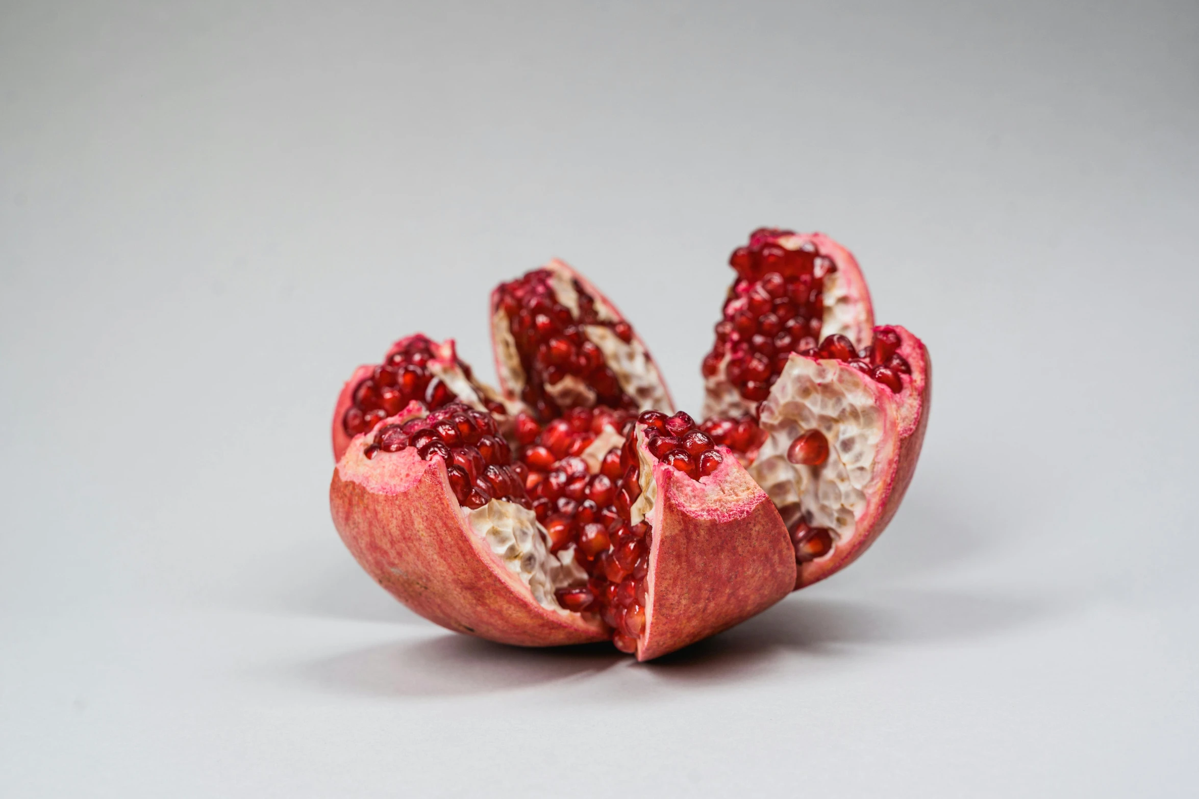 pomegranate on the surface with a white background