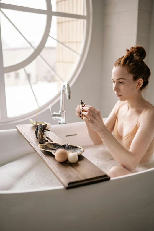 a young woman sitting in a white bath tub