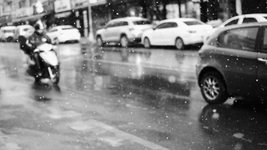 a motorbike that is in the rain with people