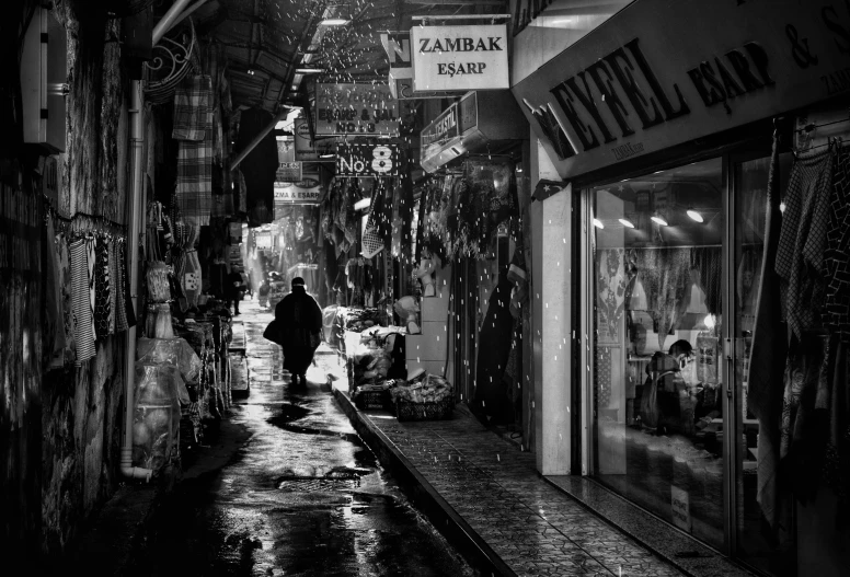 a man walks down the wet streets of a business