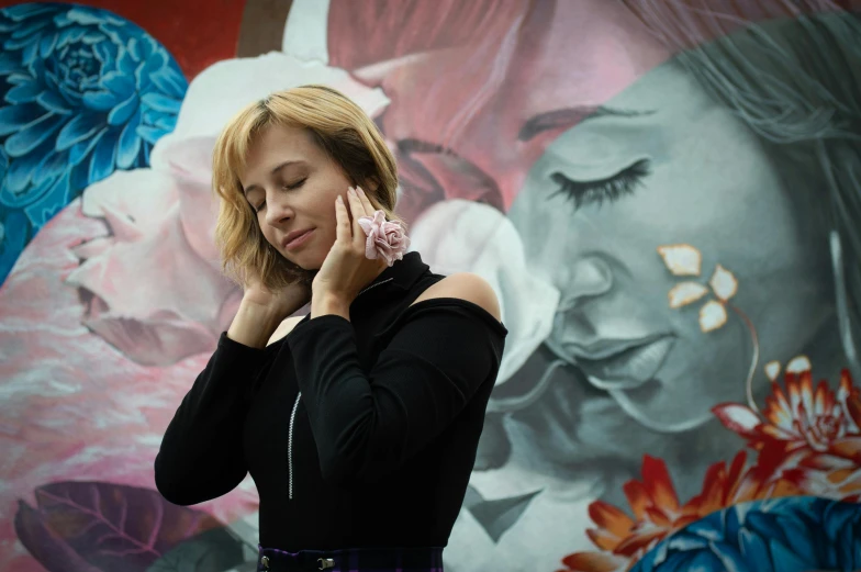 a woman is holding her hand near her ear