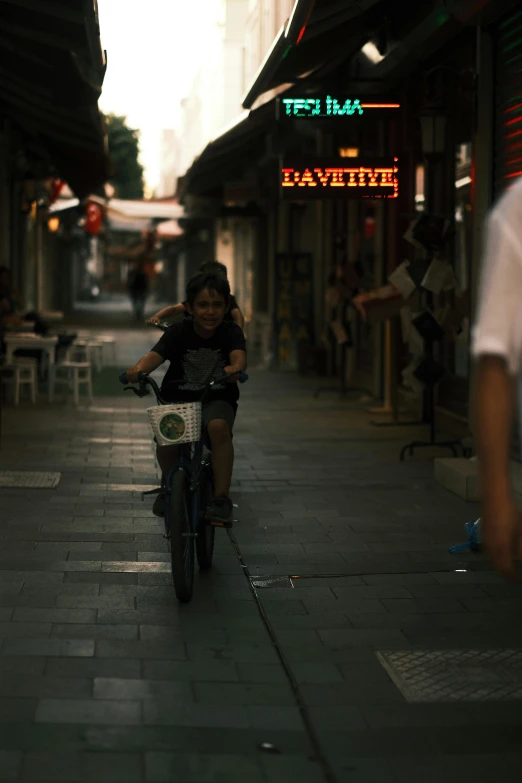 a man riding a bike down a sidewalk