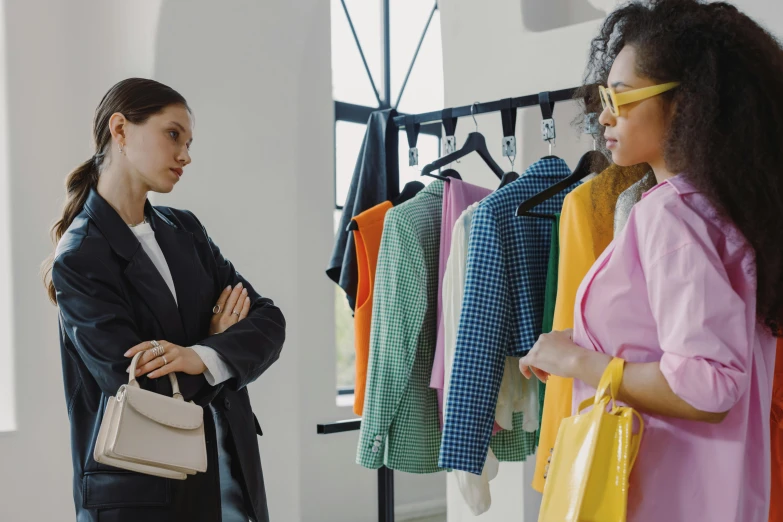 two women are looking at each other while shopping