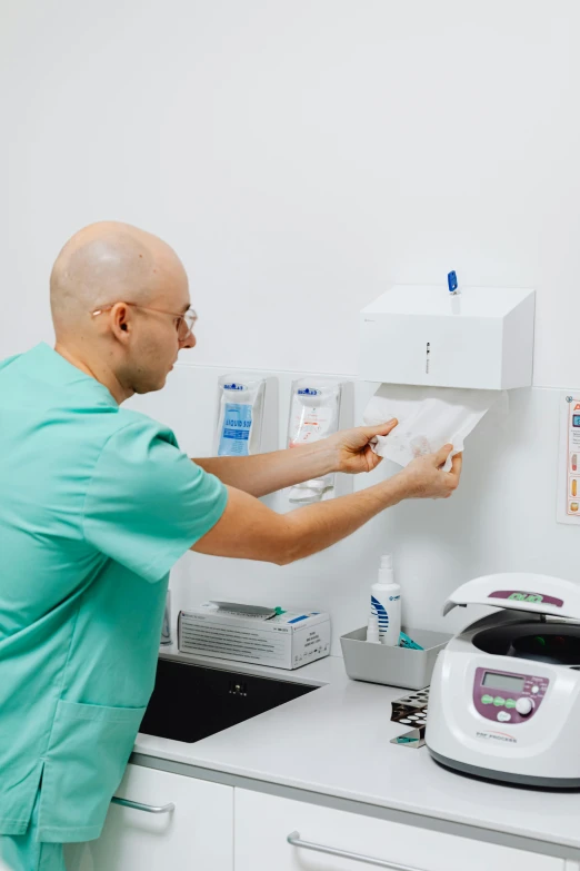 a man is removing some pieces from the printer machine