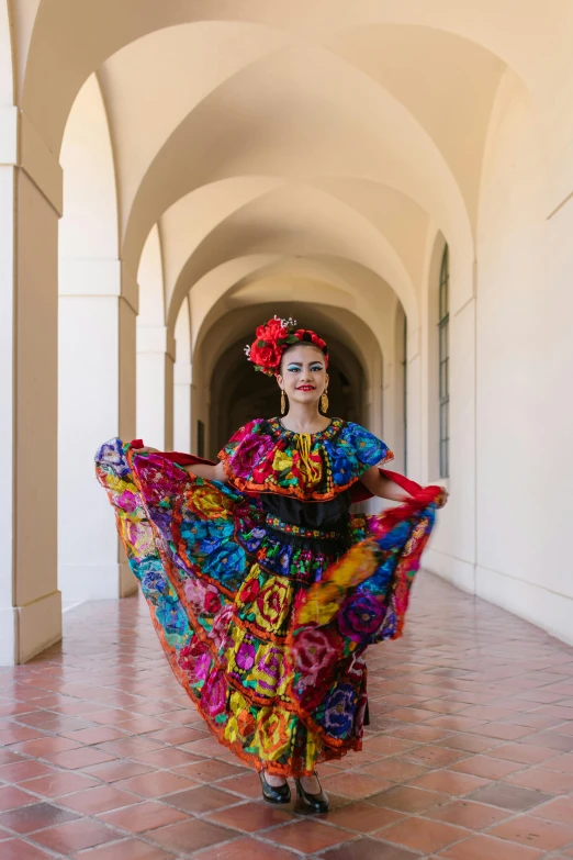 the woman is dressed in colorful clothing and posing for a picture