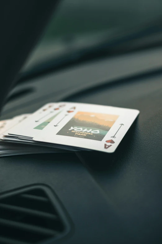 two cards on the dashboard of a car