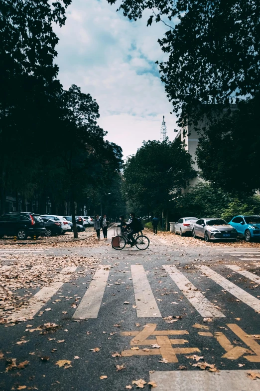 people standing in the street, some with bicycles