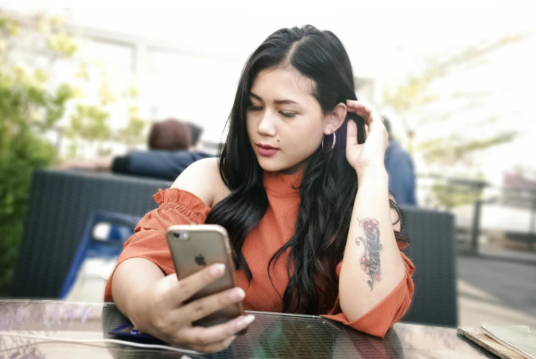 a woman looking at her phone at the table