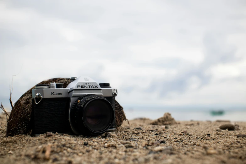 an old fashioned camera is set on the beach