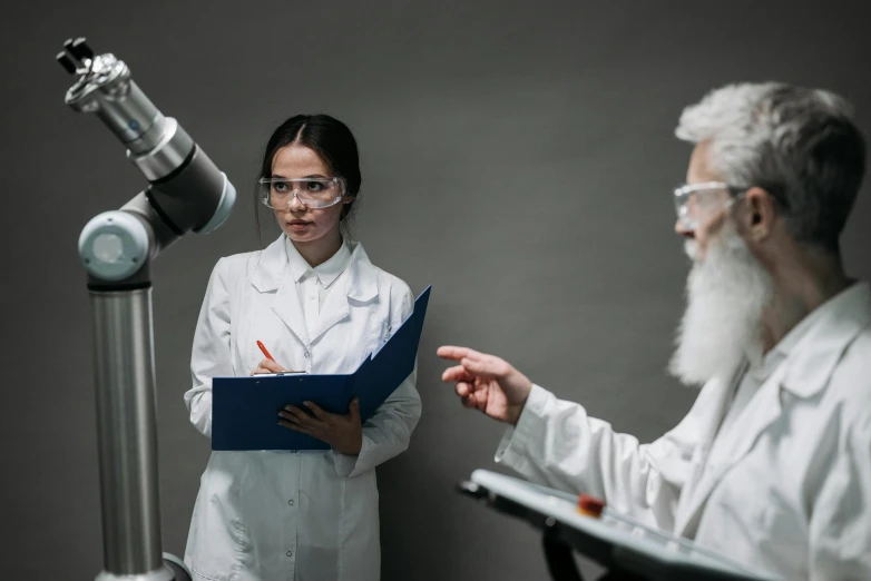 a female scientist talking to a male doctor