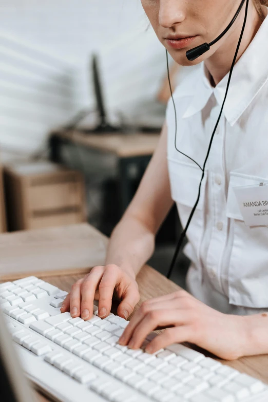 woman working at computer and wearing headset in room