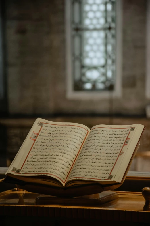 an open holy book sitting on a table