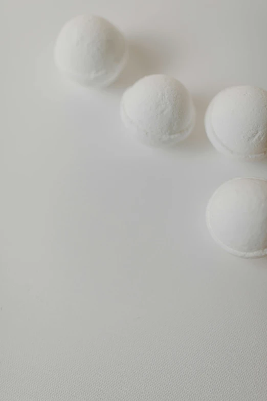 three small round balls sit on top of a table