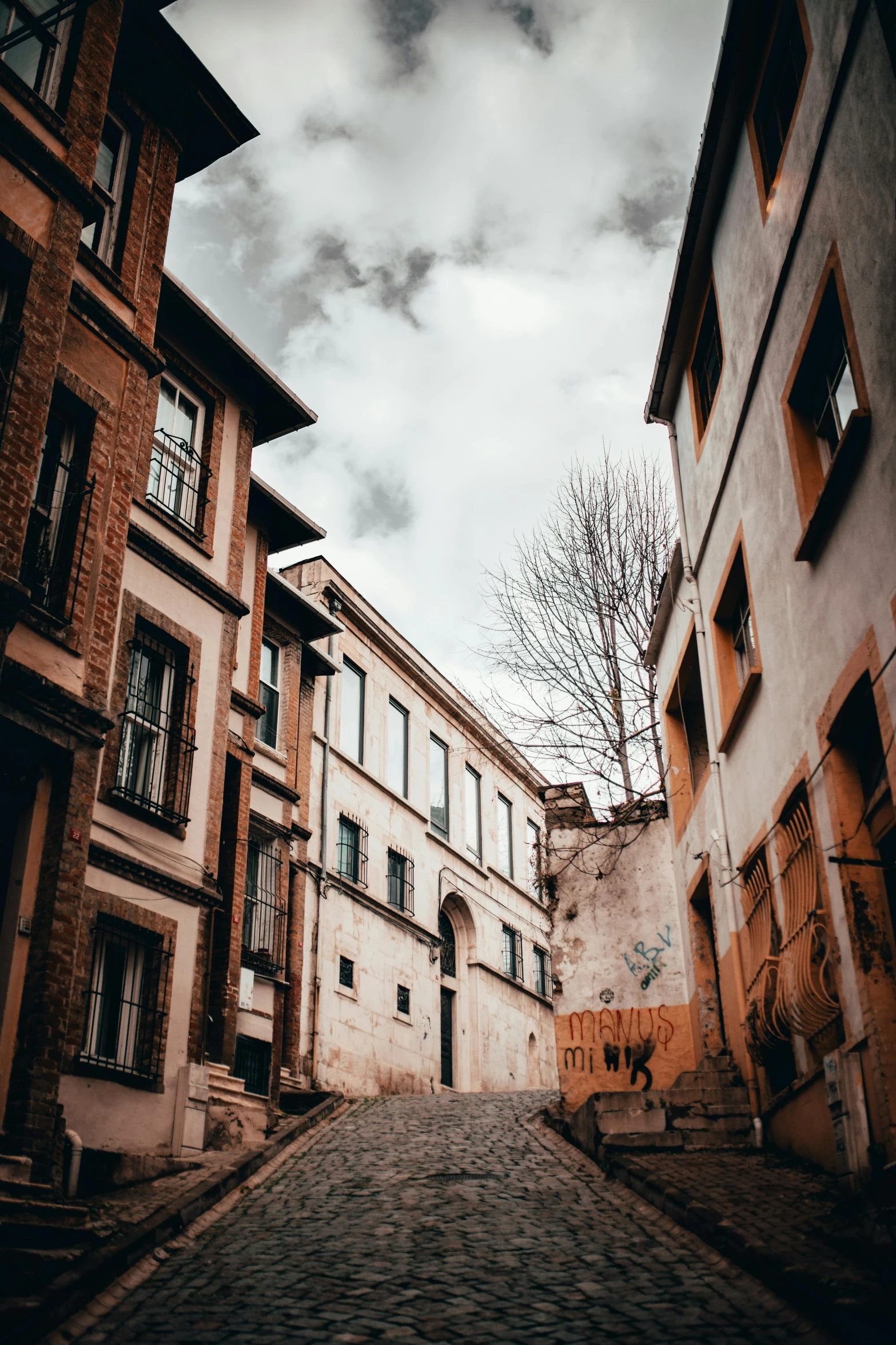 a street is lined with old buildings with balconies