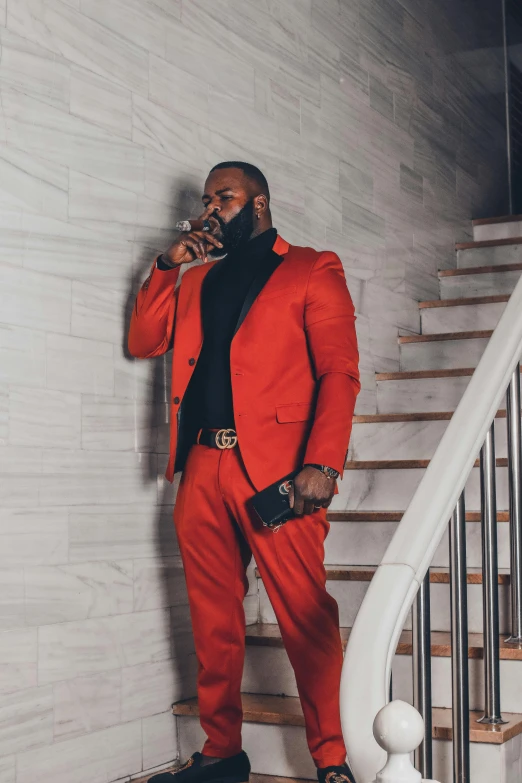 the man stands on steps dressed in a suit