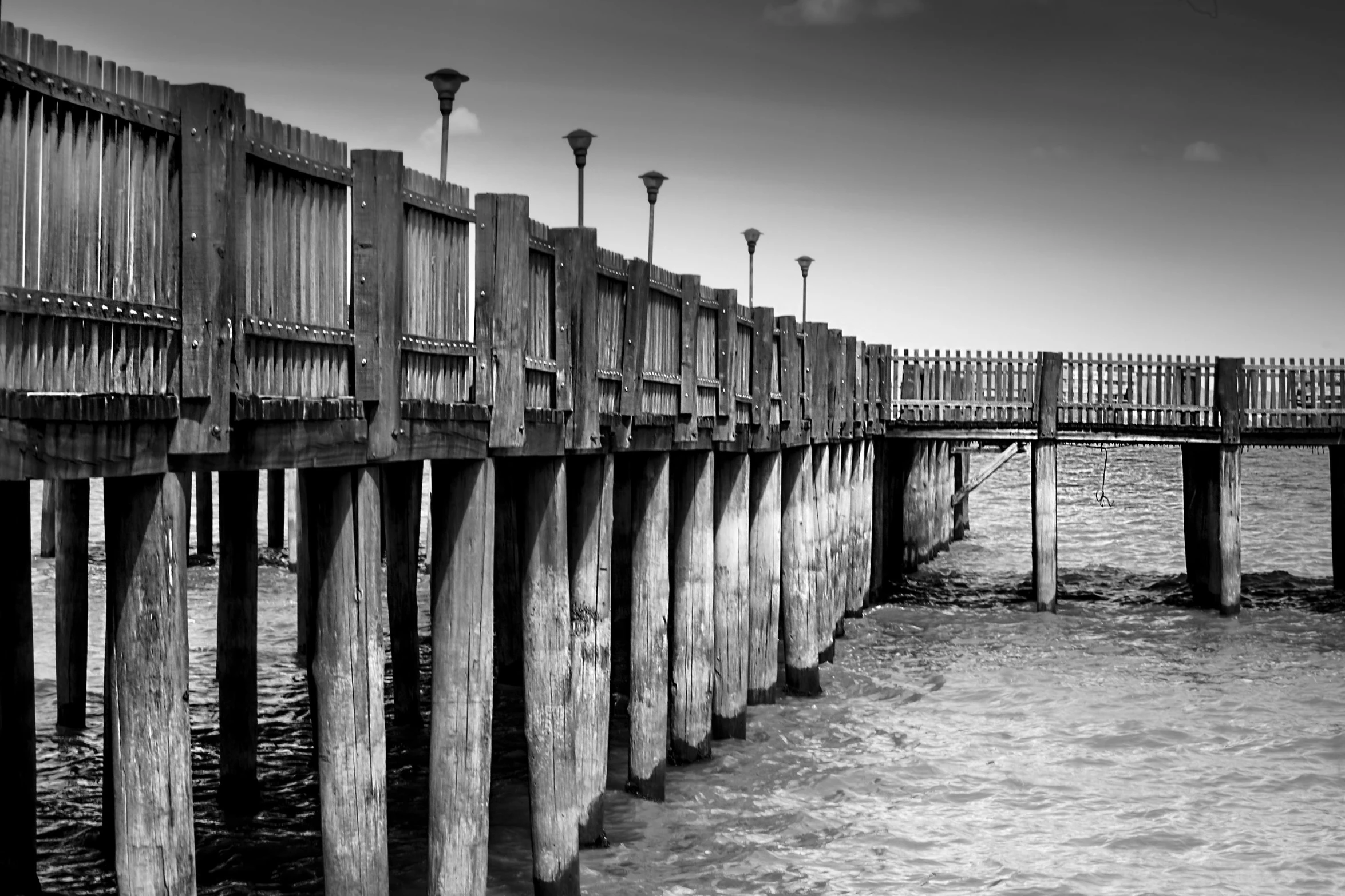 a pier on a body of water near a beach