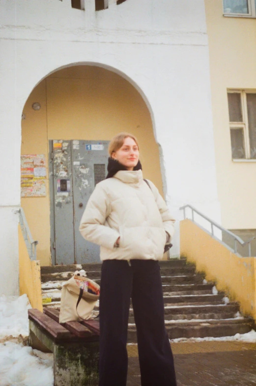 a woman in a white jacket standing outside