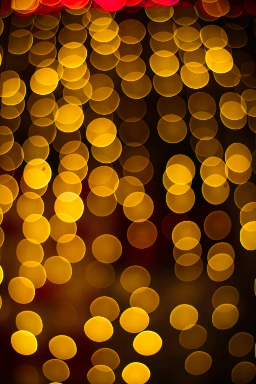 the background of a blurry image of lights and confetti