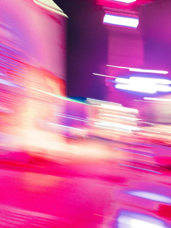 motion blur pograph of colorful lights in front of a building