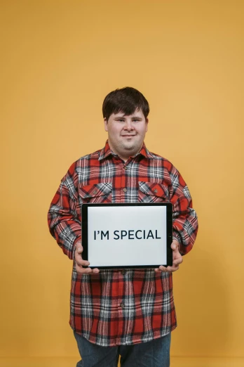 a man holding a sign that says i'm special