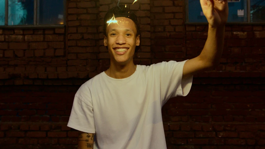 there is a young man holding a toothbrush with light on top