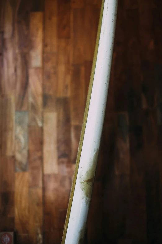 a bat lying against a wooden wall with it's top open