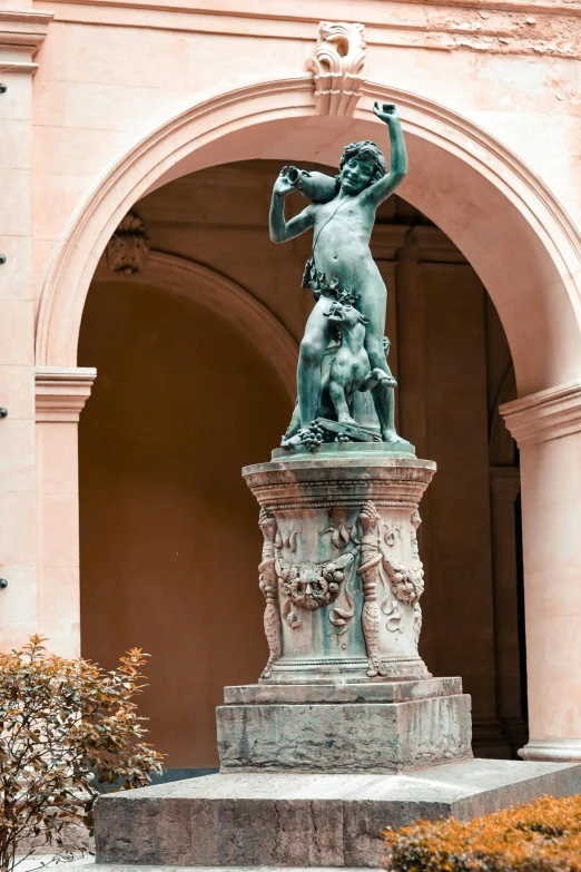 a statue with a rod is standing at the entrance