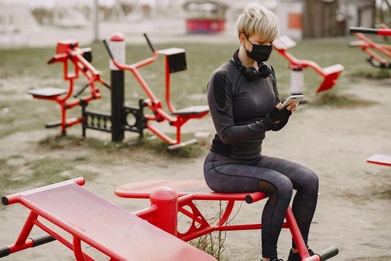 a woman sitting on a bench with a cell phone