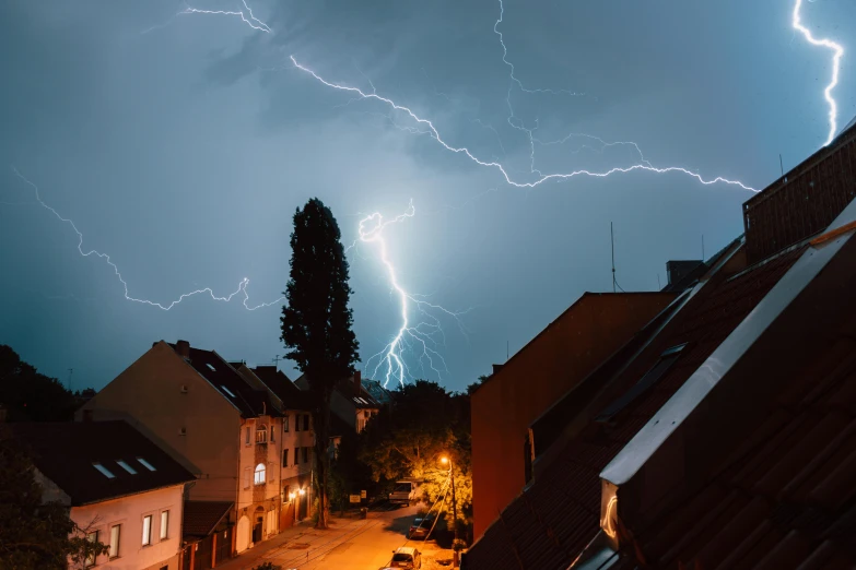 the lightning strikes brightly above a cityscape