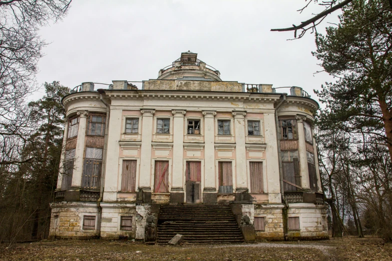 an old stone mansion with many windows and doors