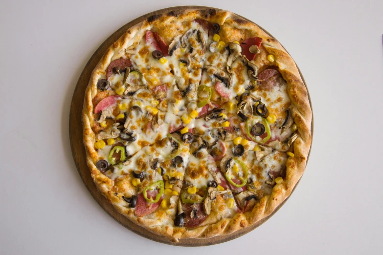 a pizza on a white table with other toppings