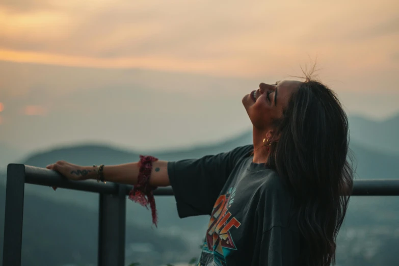 woman with long black hair looking up at the sky