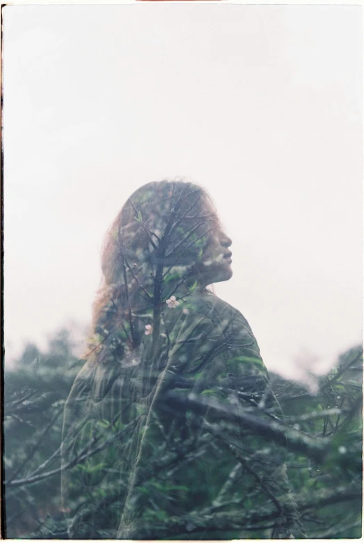 a woman is shown through a window in the rain