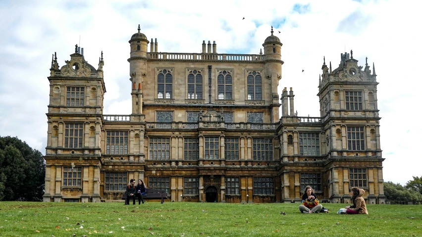 a beautiful old building that has some people in front