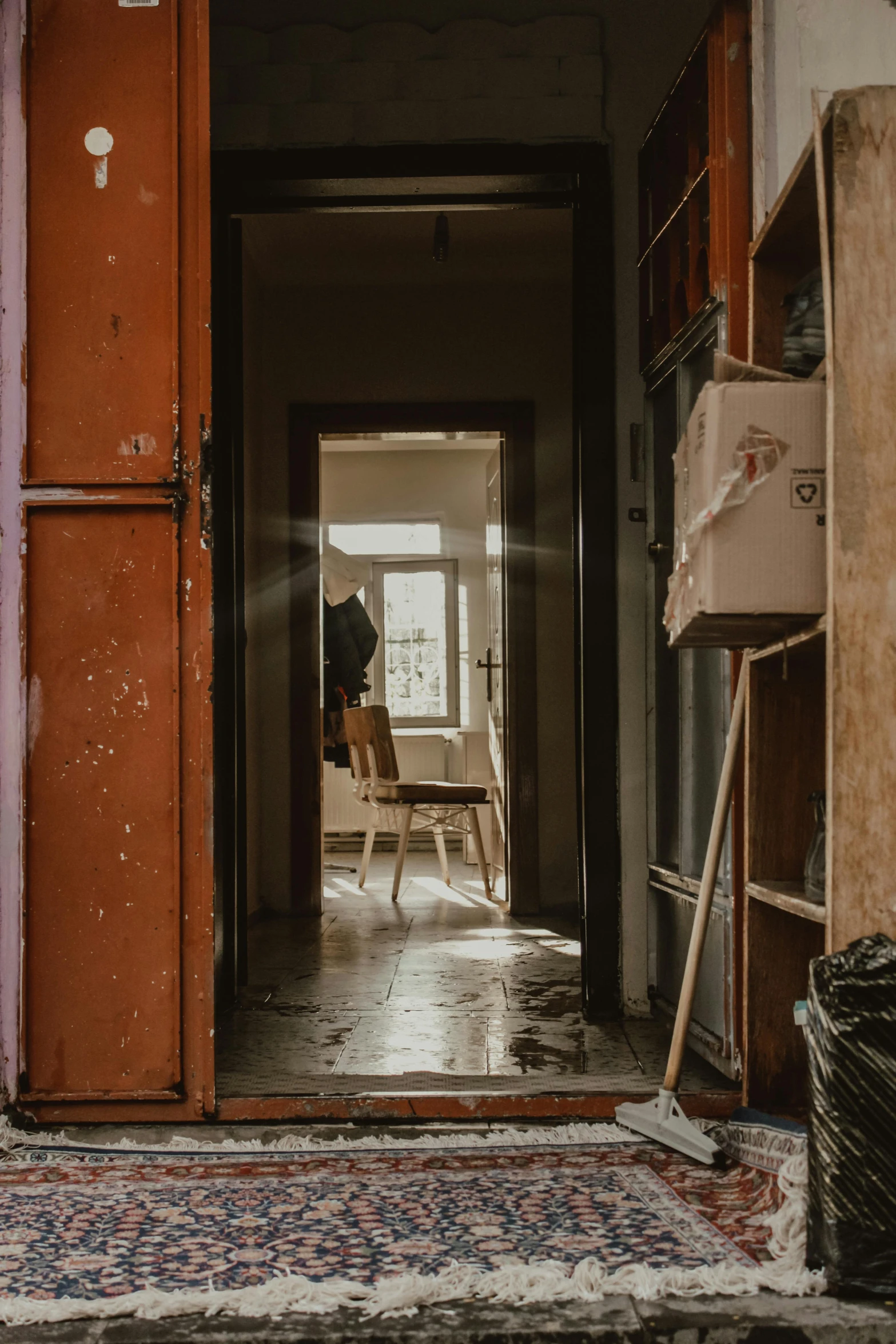 the doors to an abandoned building in front of the light