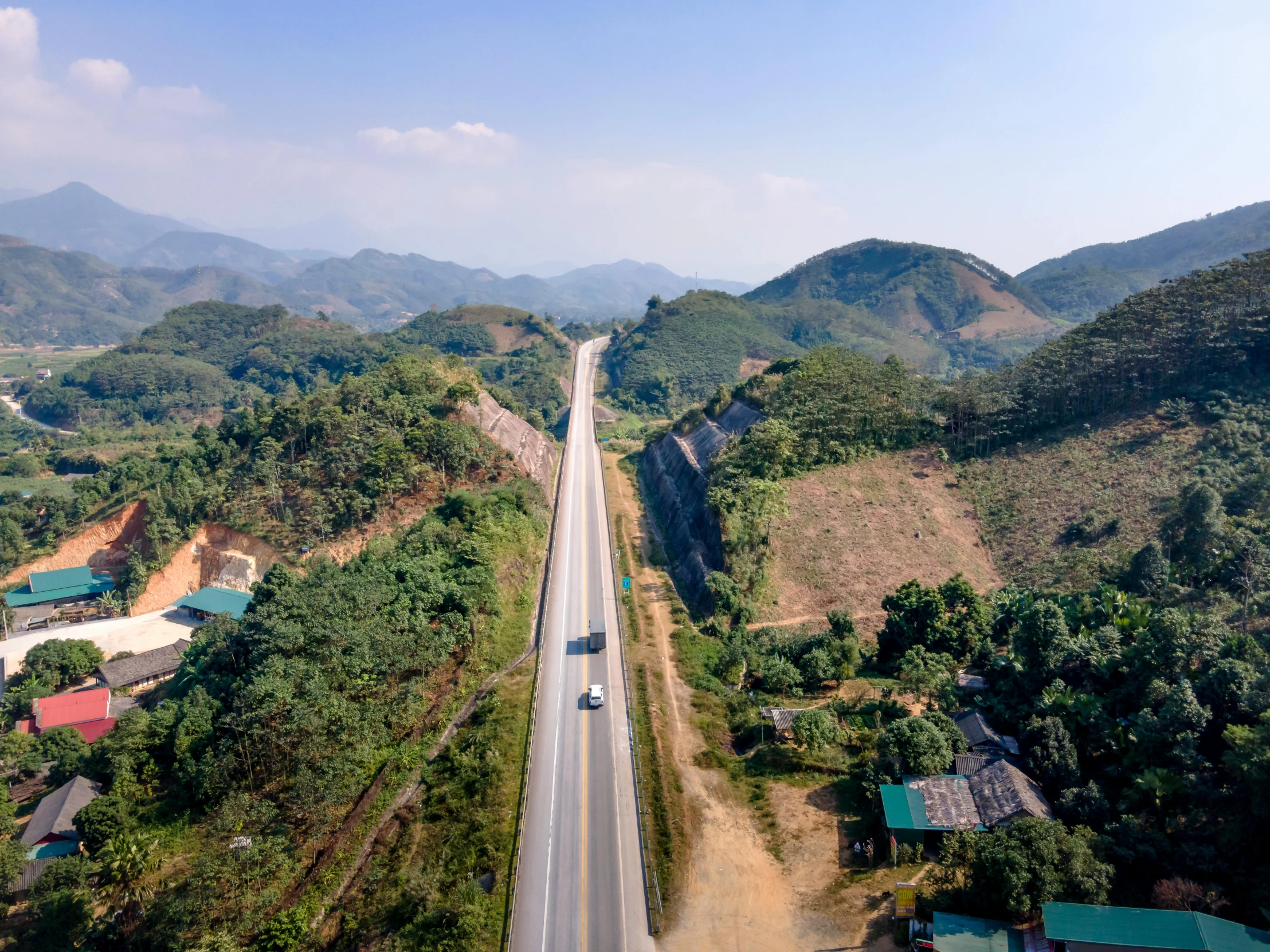 a long stretch of road with buildings and trees on both sides