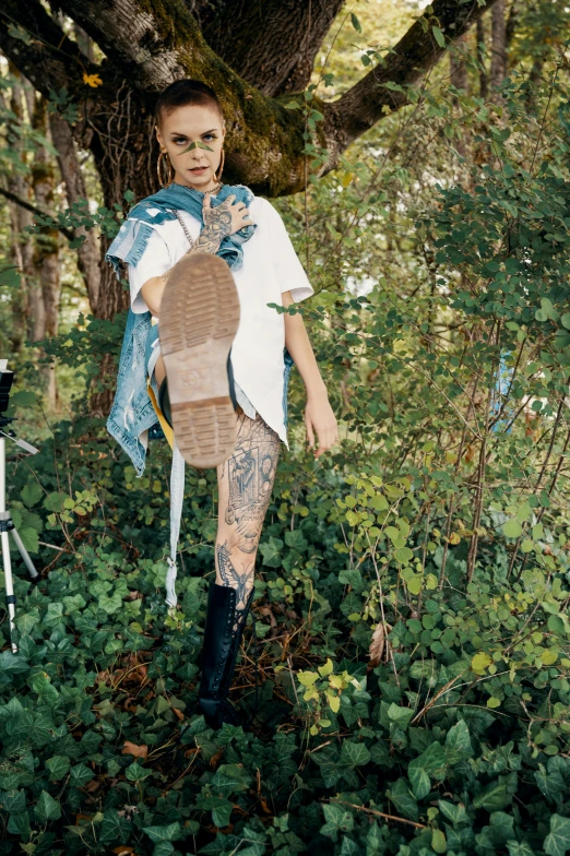 a woman is standing near many trees with her shoes on