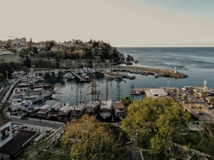 the dock of a marina on the coast has boats