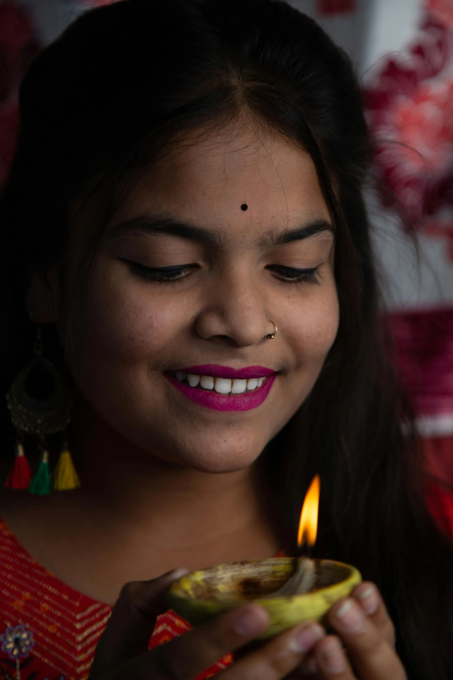 a smiling woman holds a bowl full of food