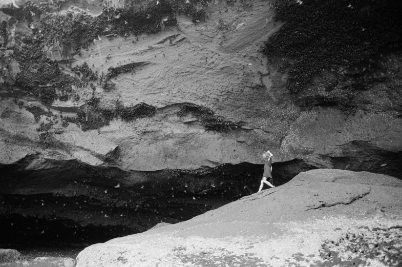 a black and white po of two people walking down a hill