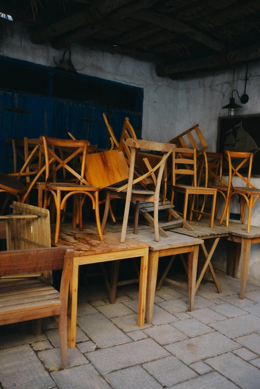 the tables and chairs are being stacked together