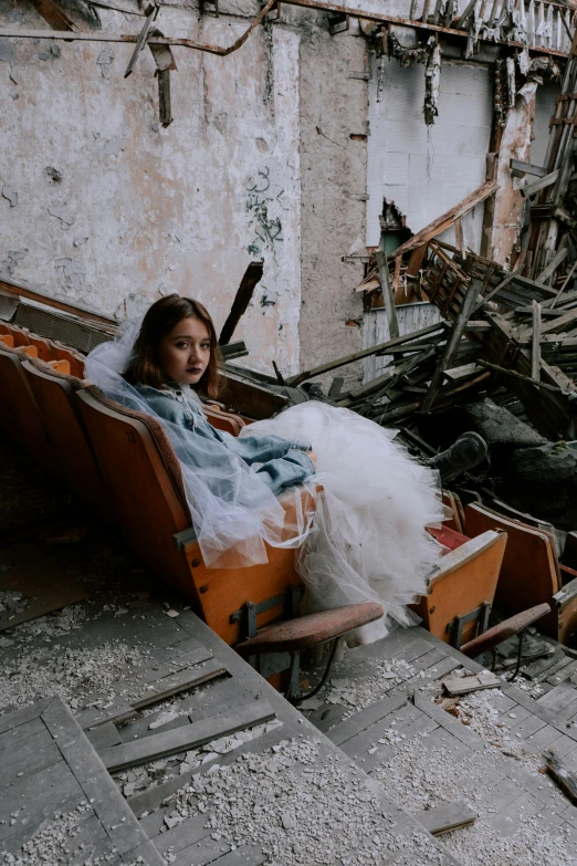 the woman sits in an abandoned rocking chair
