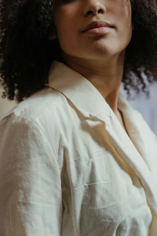 a woman with a large afro looks off to her right