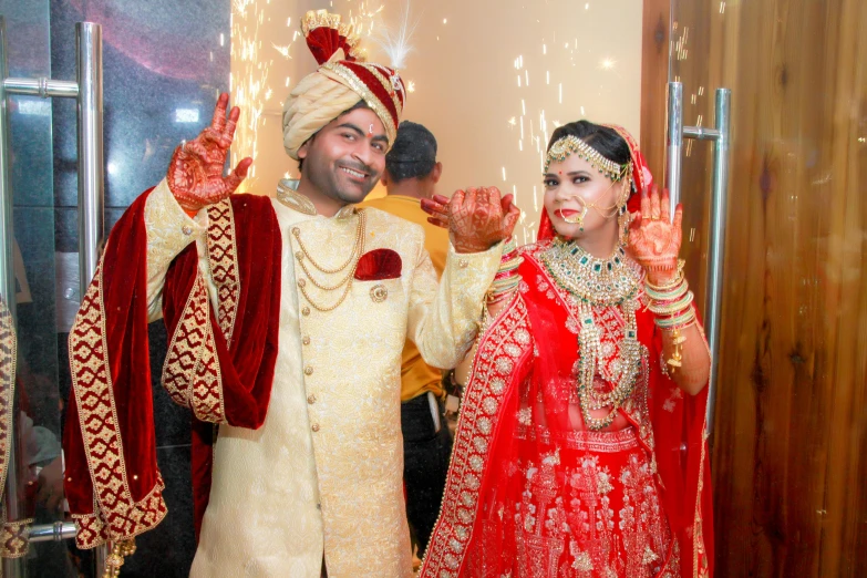 a couple dressed in indian attire at their wedding