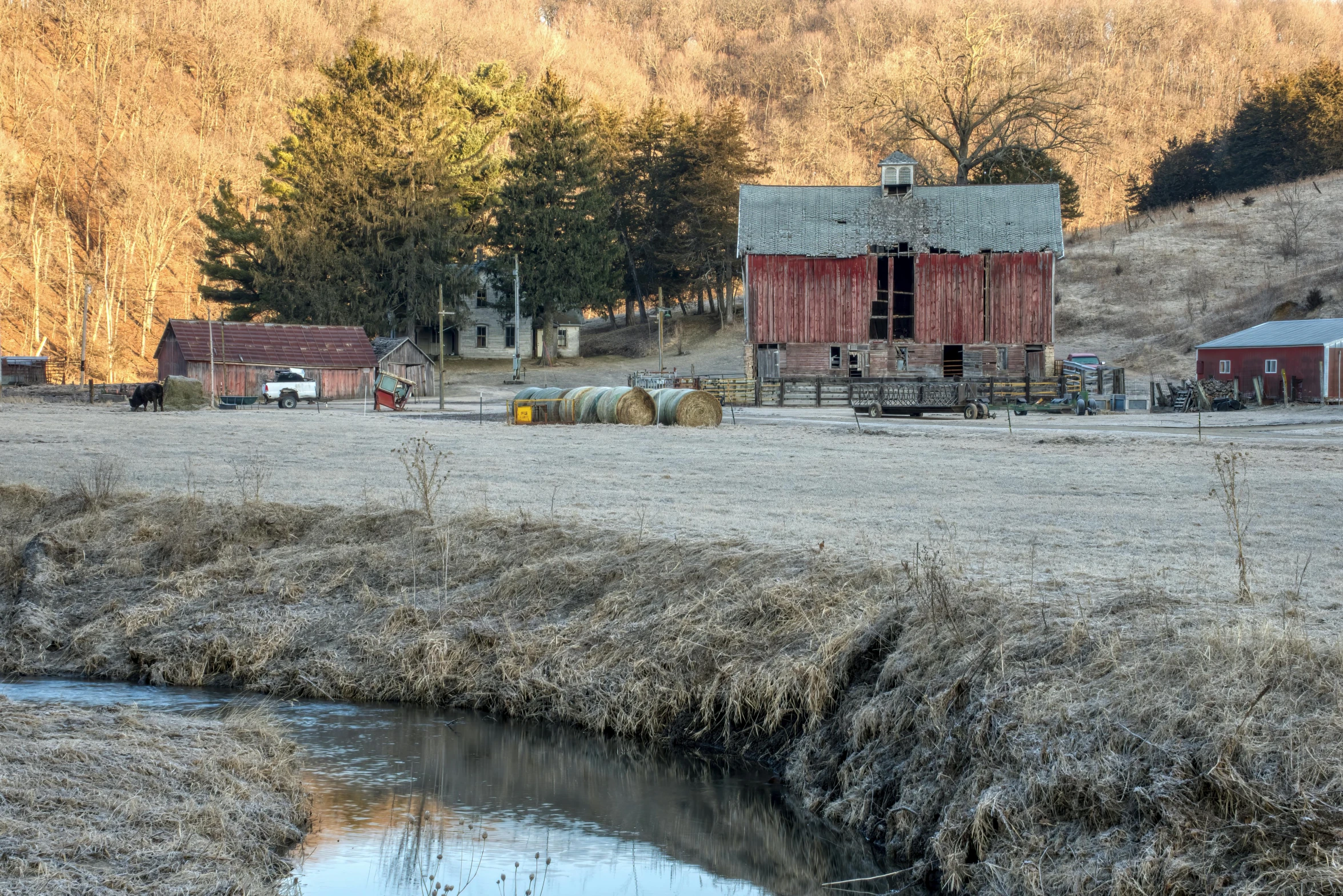 two old farm buildings, one is red the other is gray