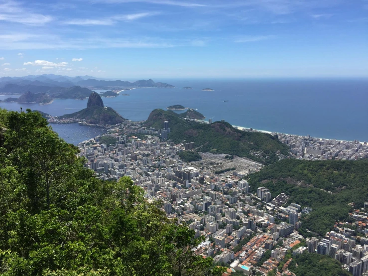 a city overlooks a hill near the ocean