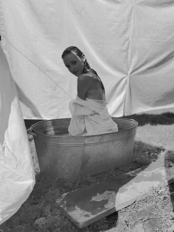 an image of a woman sitting in a basin of water