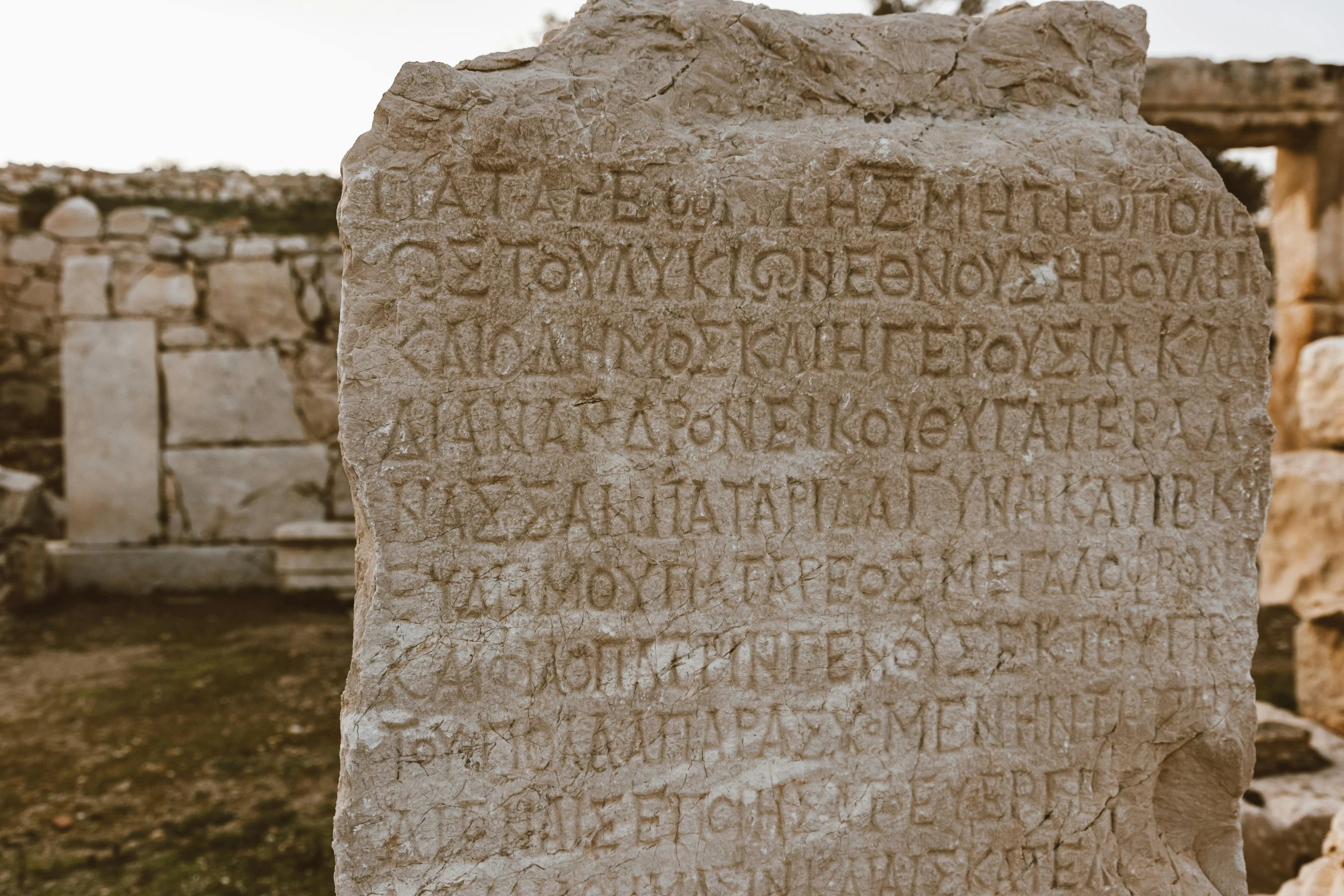 a stone wall with many writing written on it