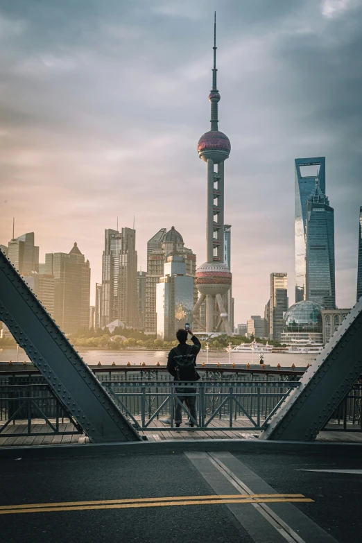 couple sitting together on bridge in asia with city skyline in the background