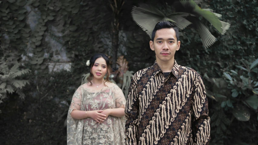 an asian man and woman posing for a picture together